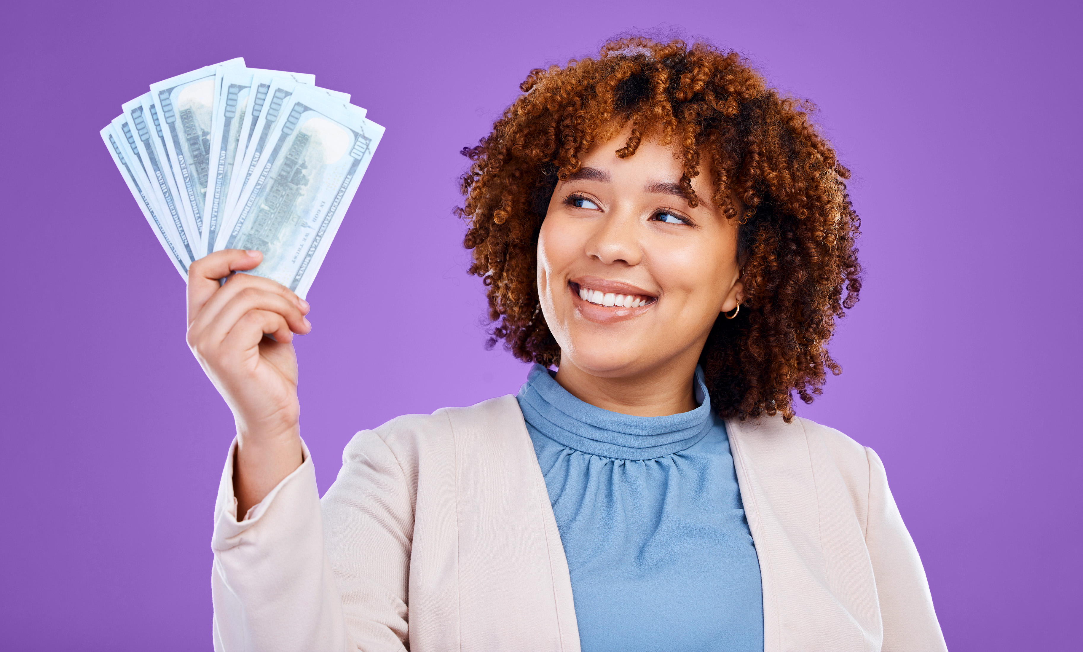 smiling woman holding cash